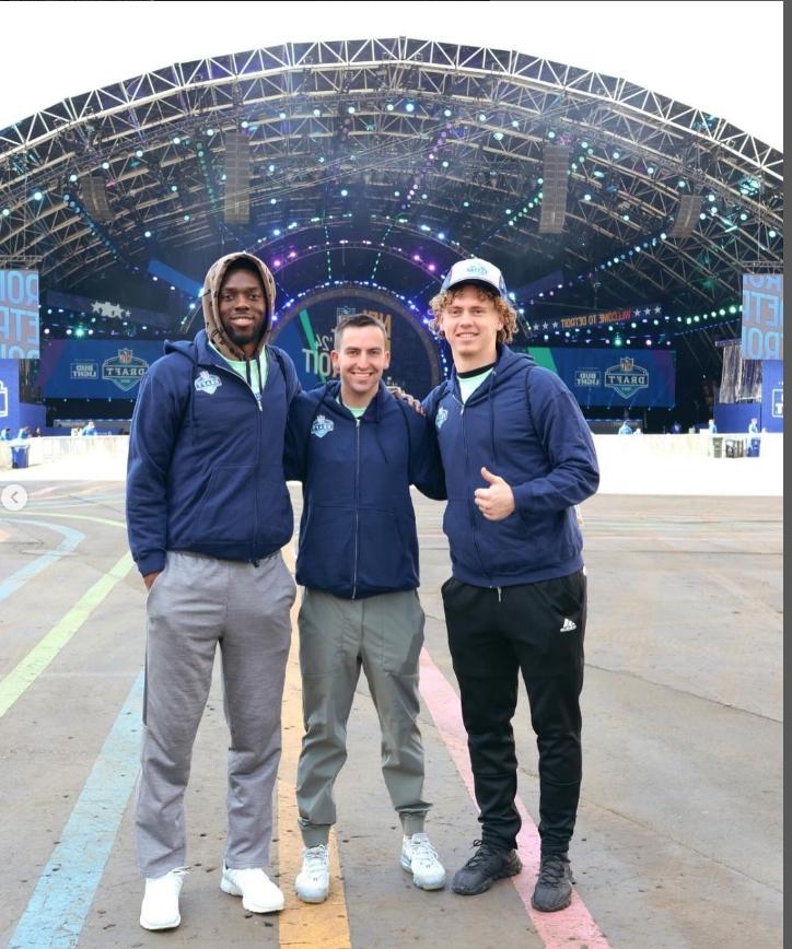 Students standing infront of NFL Draft stage